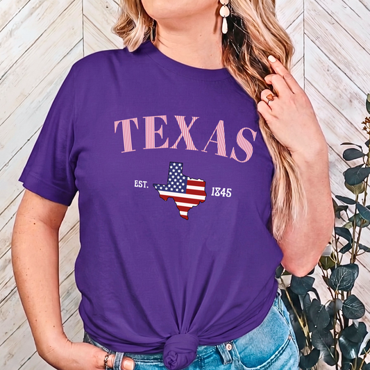 Person wearing a purple t-shirt with 'TEXAS' and a map design, sitting on a couch.