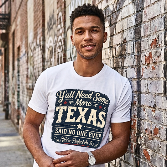 Man wearing a white t-shirt with a Texas-themed design against a brick wall.