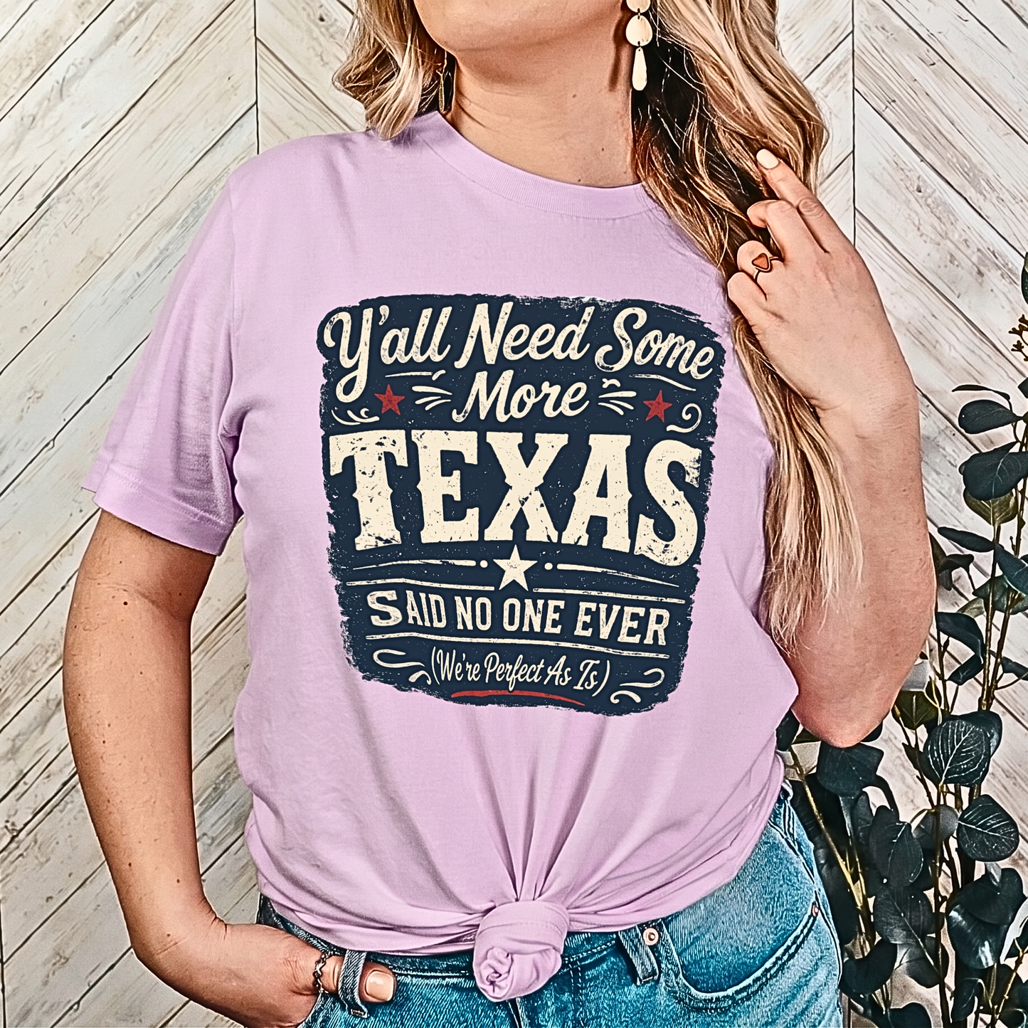 Person wearing a purple t-shirt with a Texas-themed graphic design.