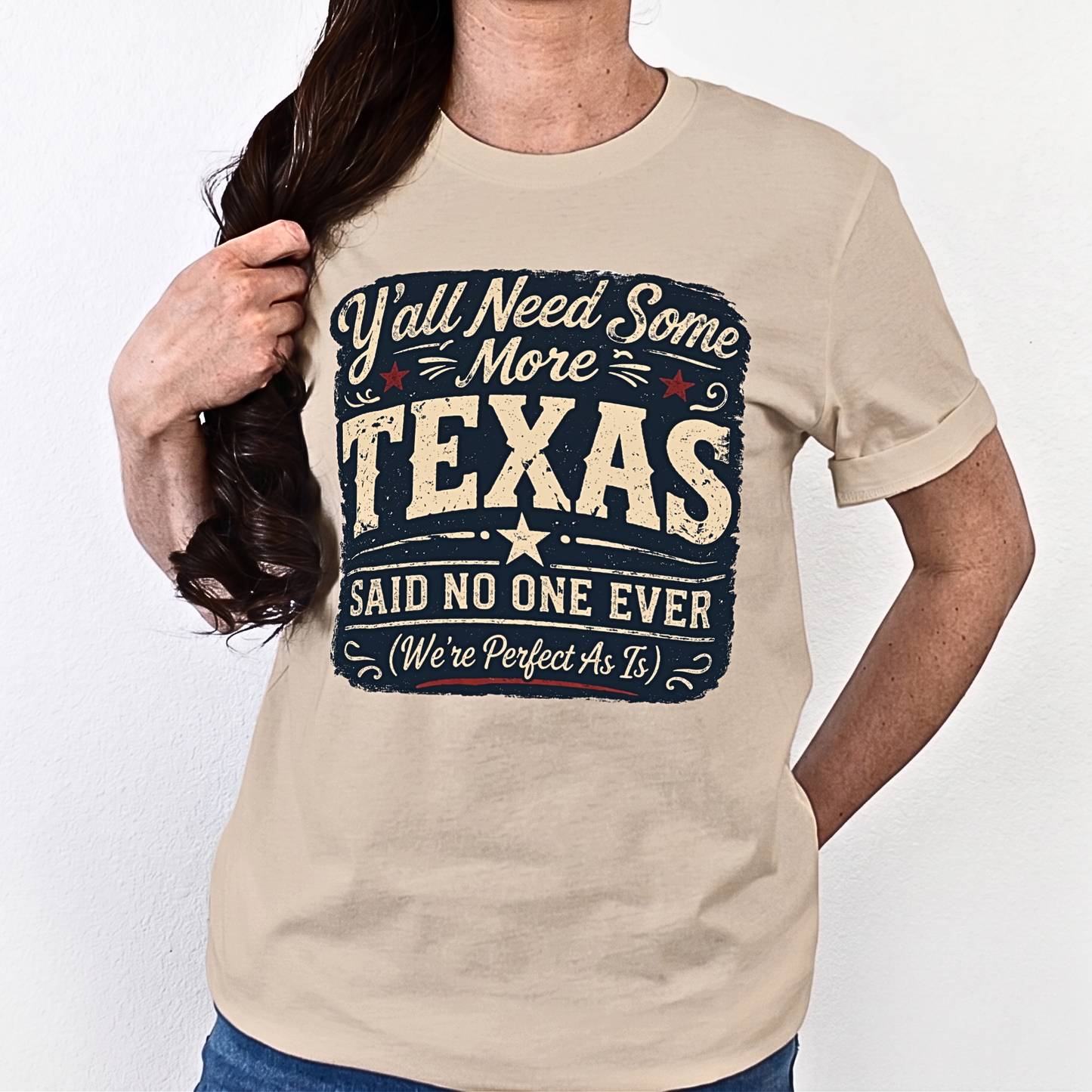 Person wearing a beige t-shirt with a humorous Texas-themed design.