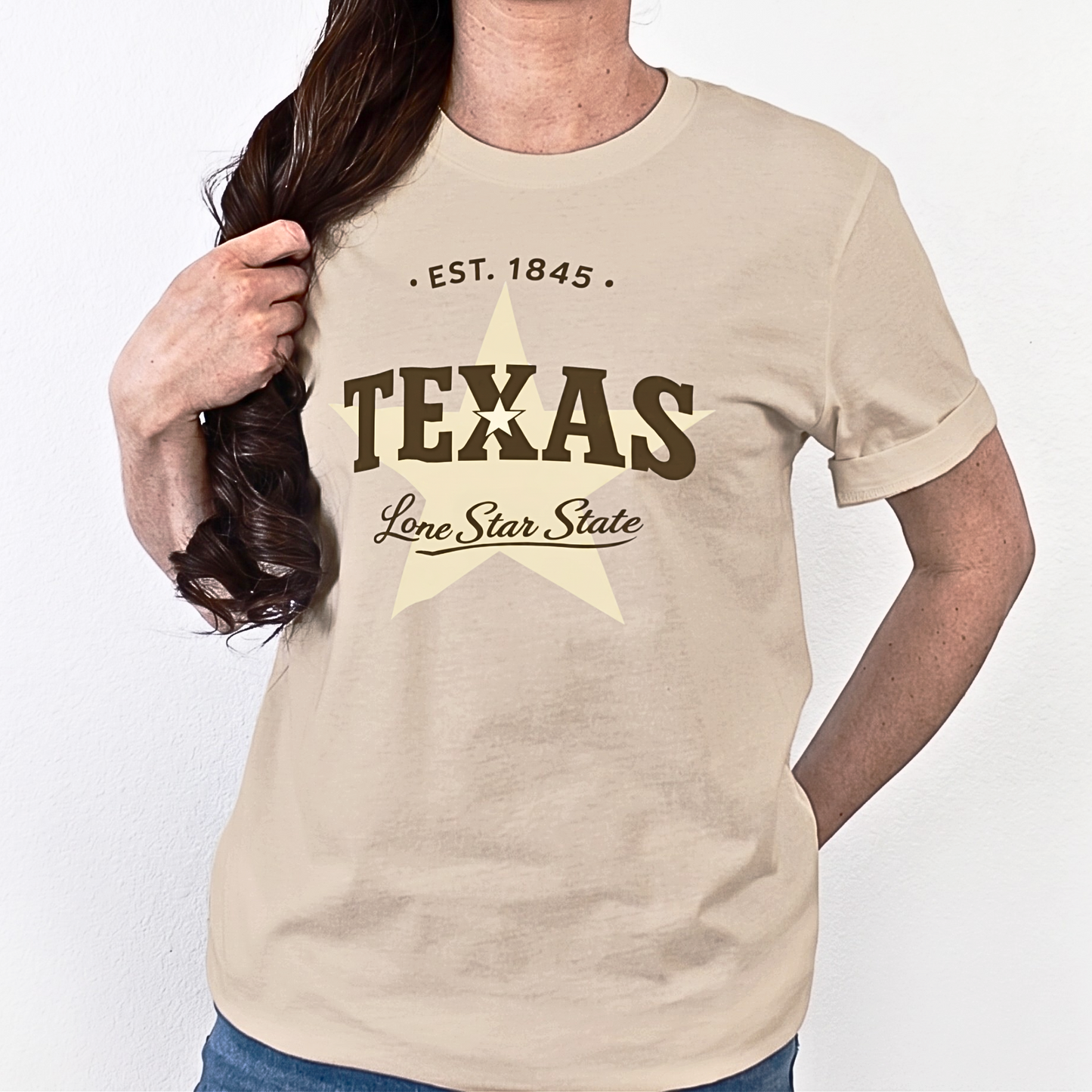 Person wearing a beige t-shirt with 'Texas Lone Star State' text and star graphic.
