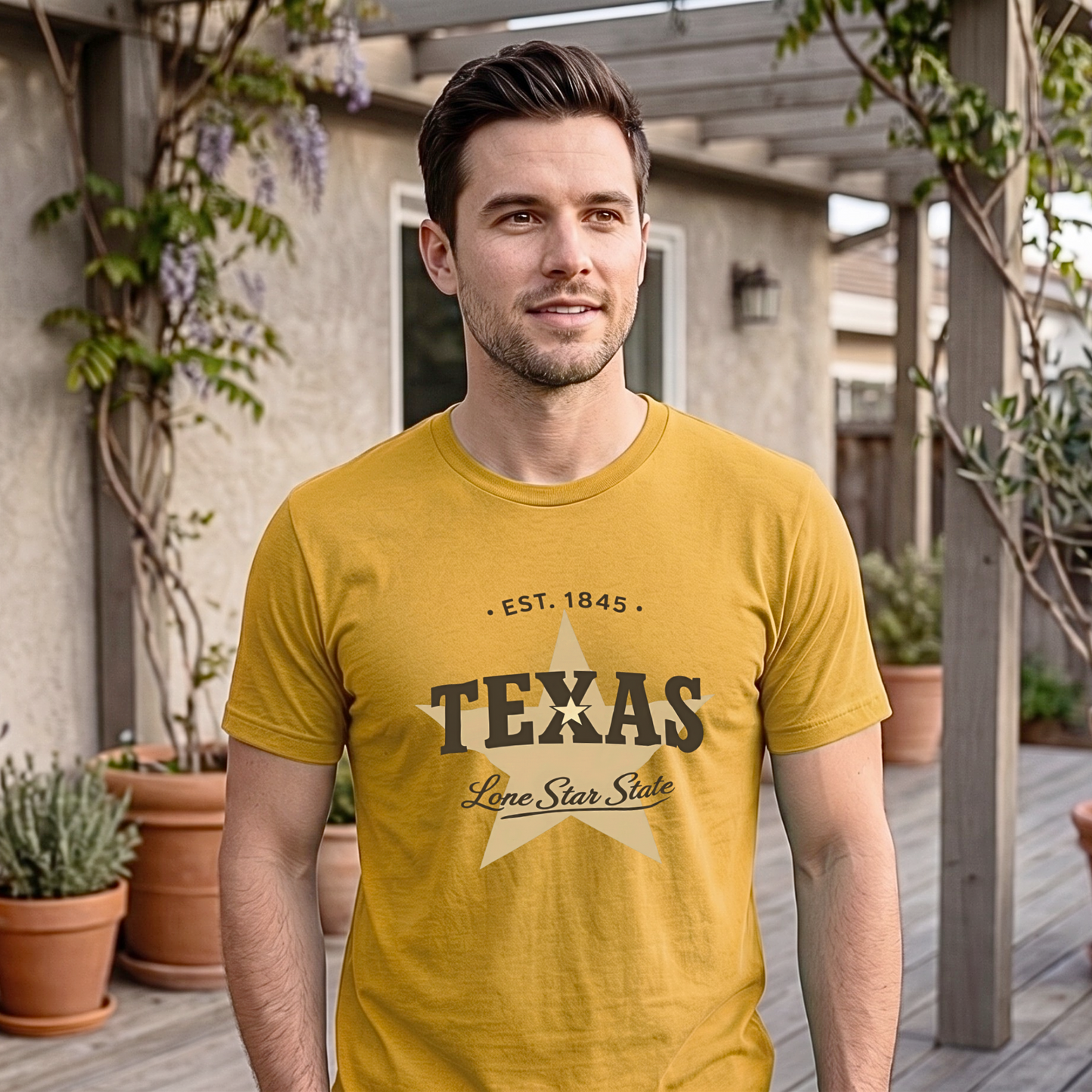 Man wearing a yellow 'Texas' t-shirt standing outdoors with plants and a building in the background