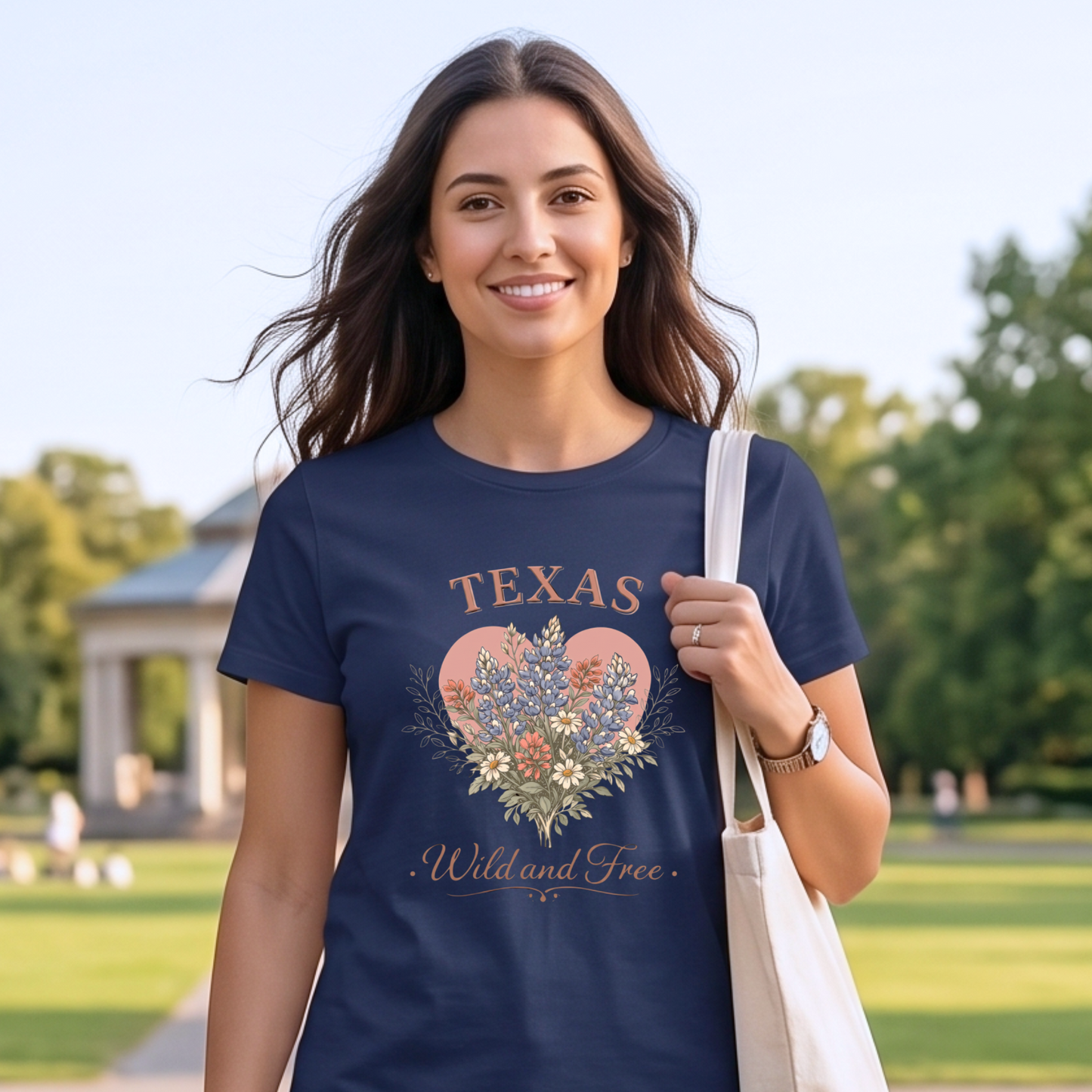 Woman wearing a navy blue t-shirt with 'Texas Wild and Free' design in a park.