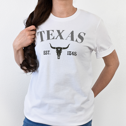 White t-shirt with 'Texas' and longhorn skull design on a plain background