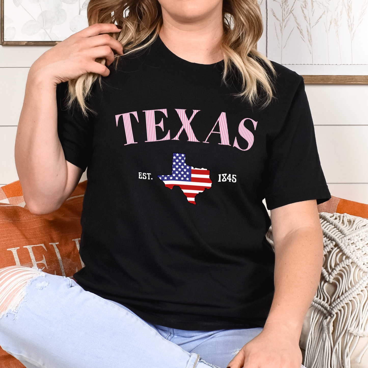 Person wearing a black t-shirt with 'TEXAS' and a map of Texas design.