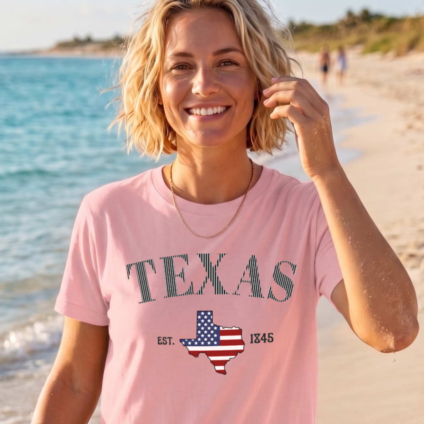 Woman wearing a pink 'TEXAS' t-shirt on a beach