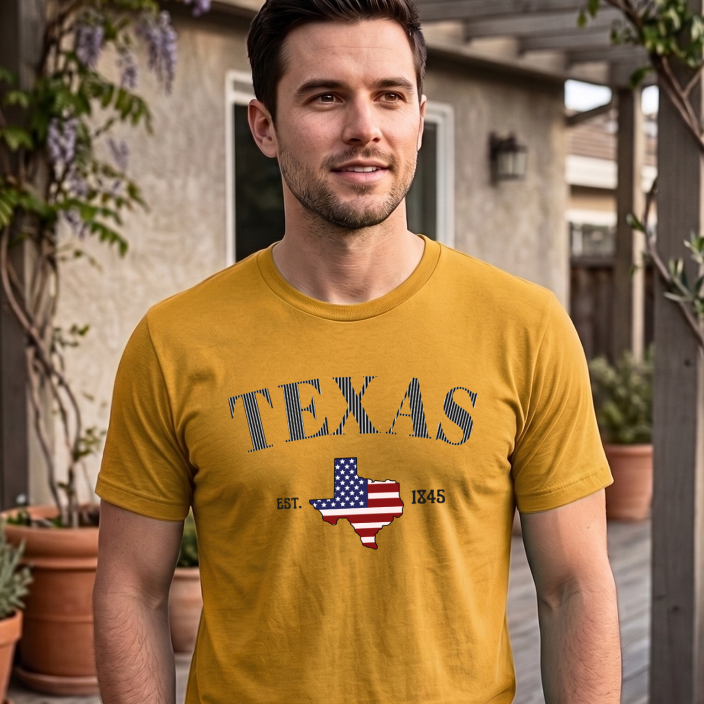 Man wearing a yellow t-shirt with an American flag design with the text Texas in striped design, standing outdoors.
