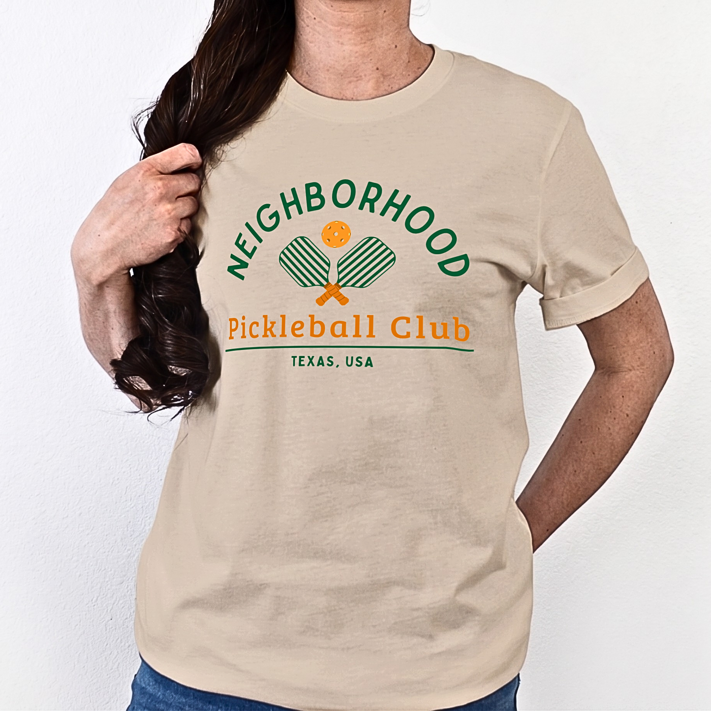 Beige or tan t-shirt with 'Neighborhood Pickleball Club Texas,USA' text and graphics on a white background